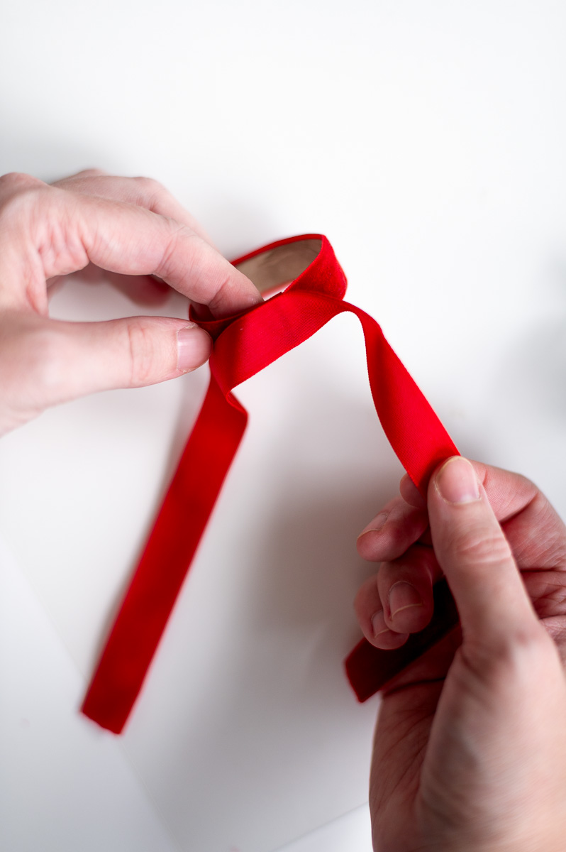 Step-by-step tutorial showing how to make red velvet DIY napkin rings for Christmas entertaining.