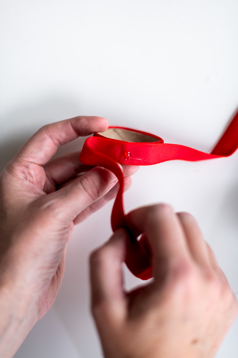 Step-by-step tutorial showing how to make red velvet DIY napkin rings for Christmas entertaining.