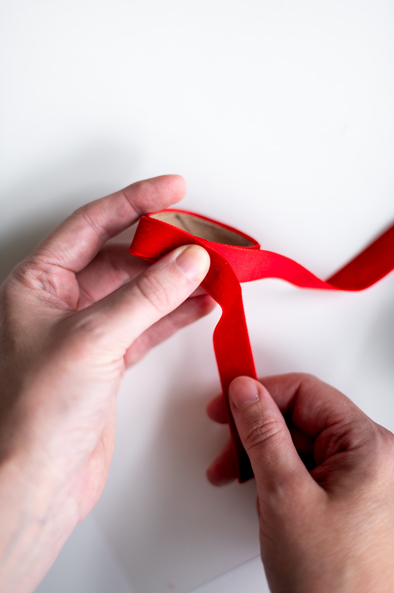 Step-by-step tutorial showing how to make red velvet DIY napkin rings for Christmas entertaining.