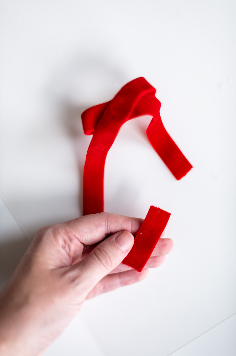 Step-by-step tutorial showing how to make red velvet DIY napkin rings for Christmas entertaining.