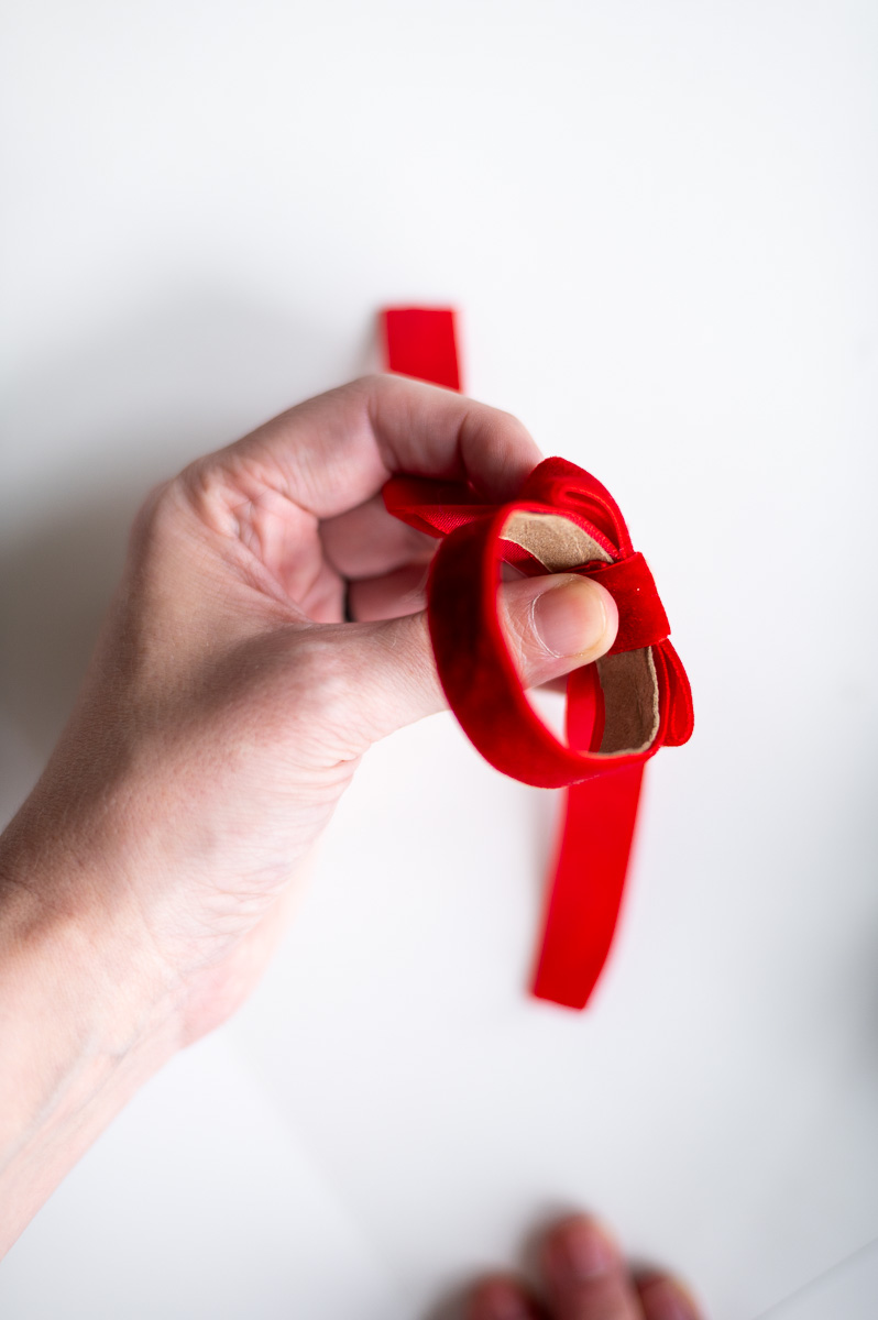 Step-by-step tutorial showing how to make red velvet DIY napkin rings for Christmas entertaining.
