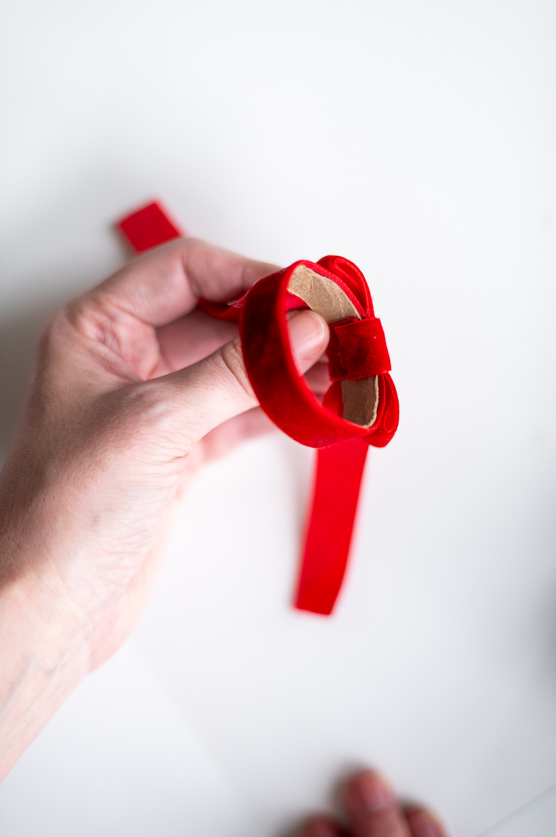 Step-by-step tutorial showing how to make red velvet DIY napkin rings for Christmas entertaining.