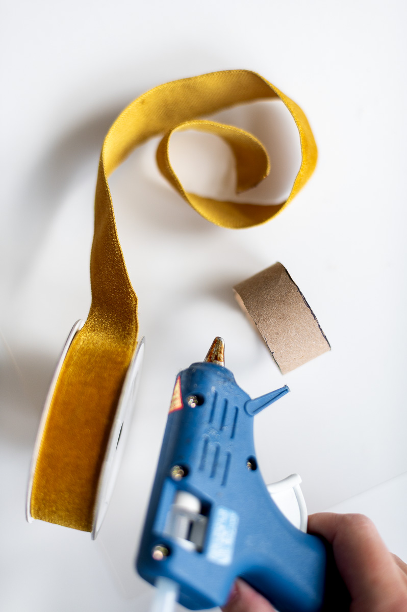 Step-by-step tutorial showing how to make gold velvet DIY napkin rings for Thanksgiving entertaining.