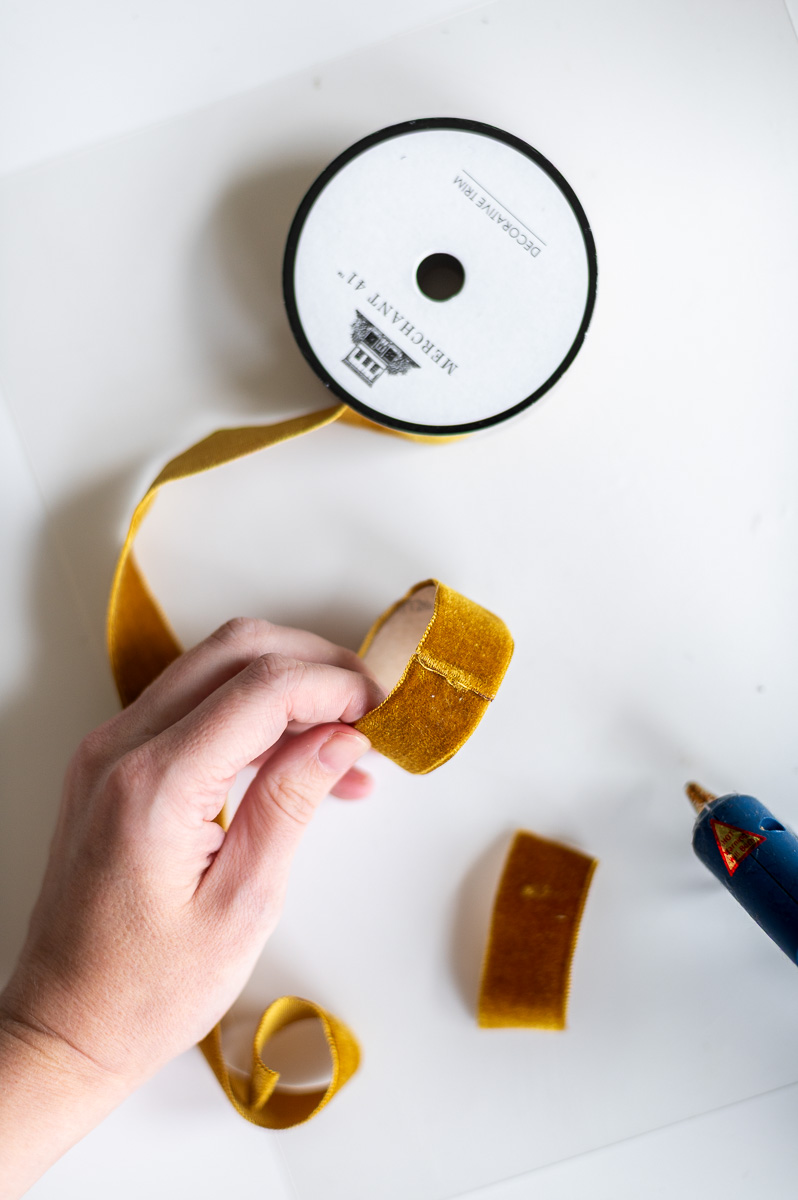 Step-by-step tutorial showing how to make gold velvet DIY napkin rings for Thanksgiving entertaining.