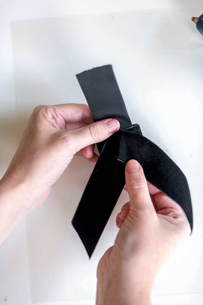 Step-by-step tutorial showing how to make black velvet DIY Napkin Rings for holiday entertaining.