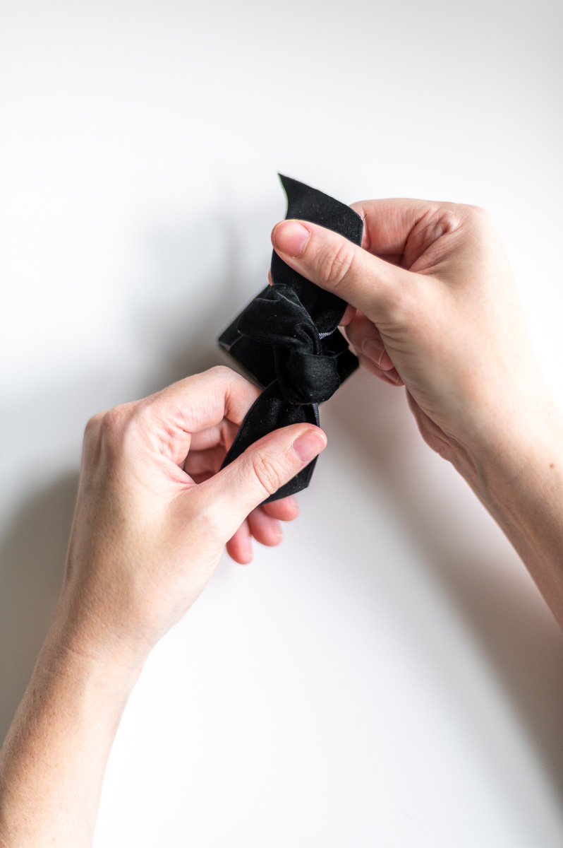 Step-by-step tutorial showing how to make black velvet DIY Napkin Rings for holiday entertaining.