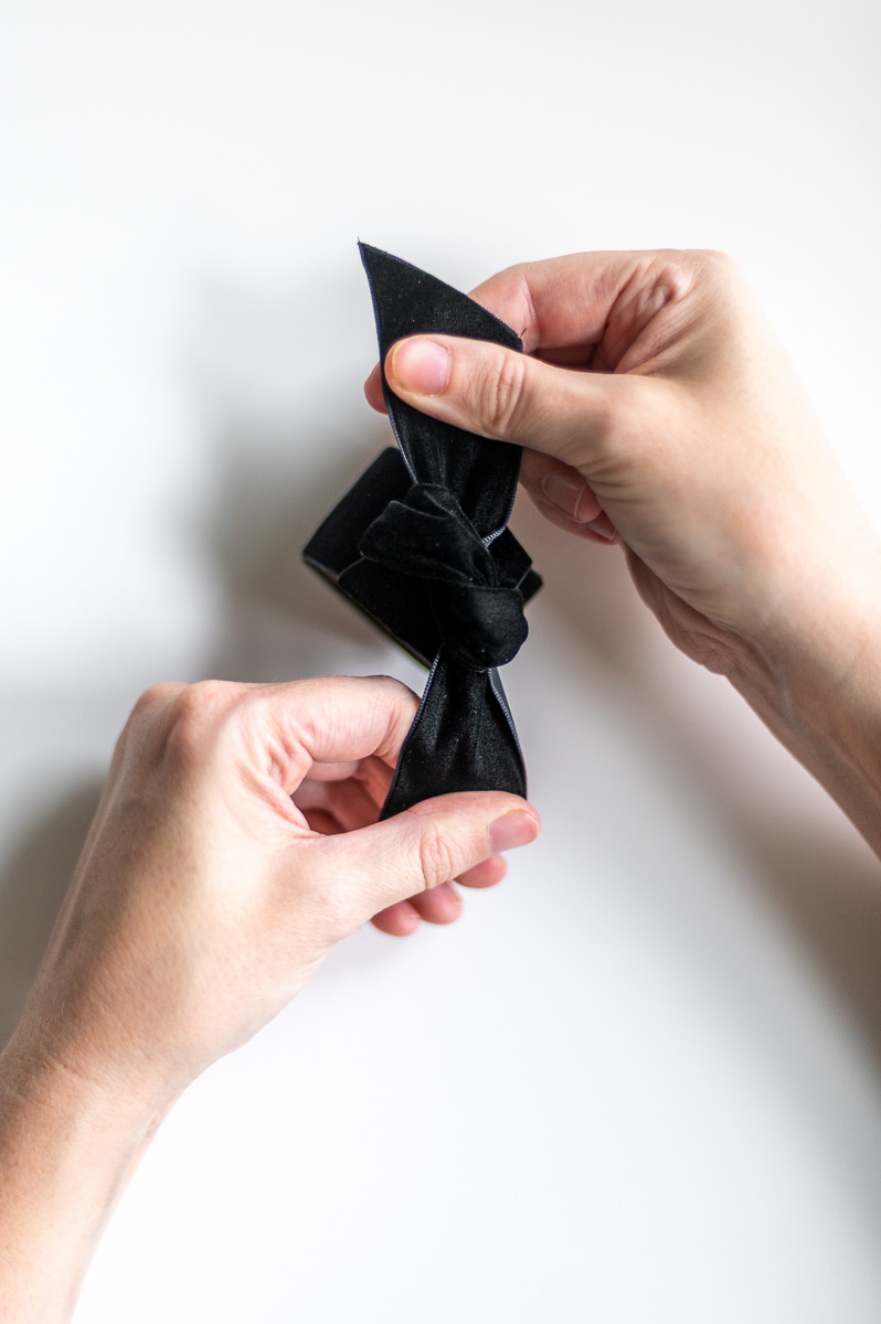 Step-by-step tutorial showing how to make black velvet DIY Napkin Rings for holiday entertaining.