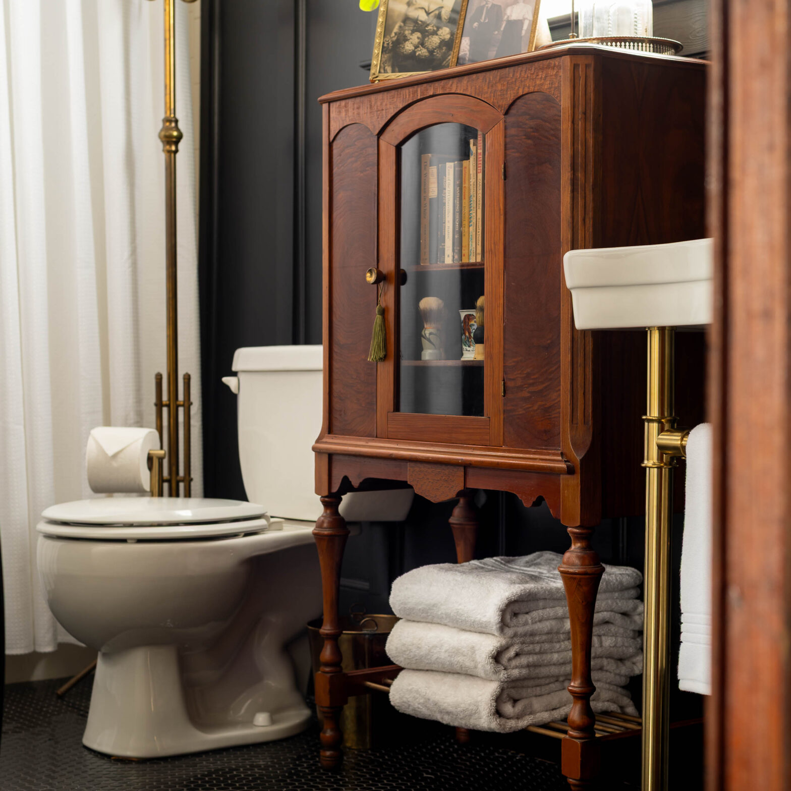 vintage bathroom cabinet makeover with brass shelf