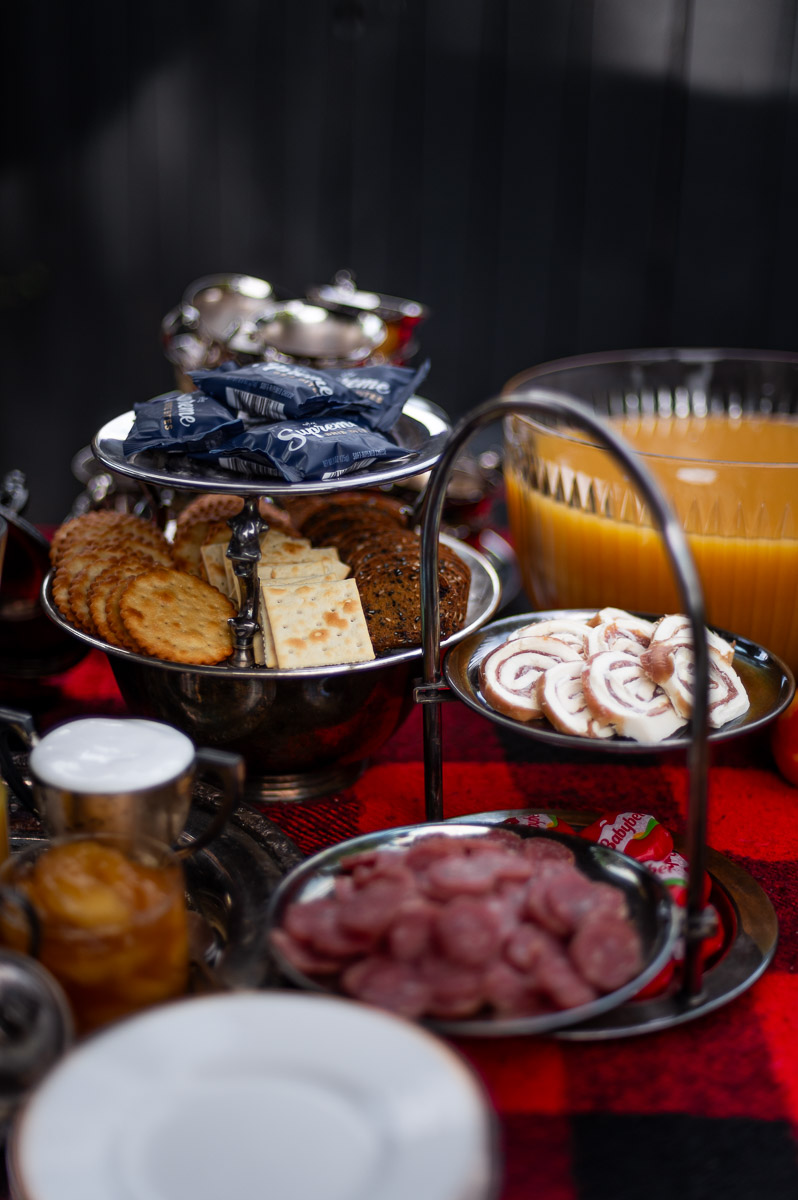 Savory s’mores charcuterie board with roasted cheeses, crackers, and meats for a fall bonfire s’mores party.