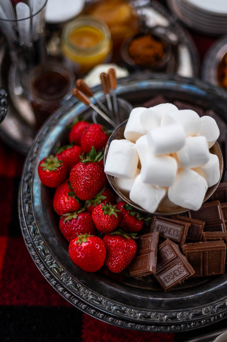 Classic s’mores board featuring assorted chocolates and marshmallows styled for a fall bonfire s’mores station.