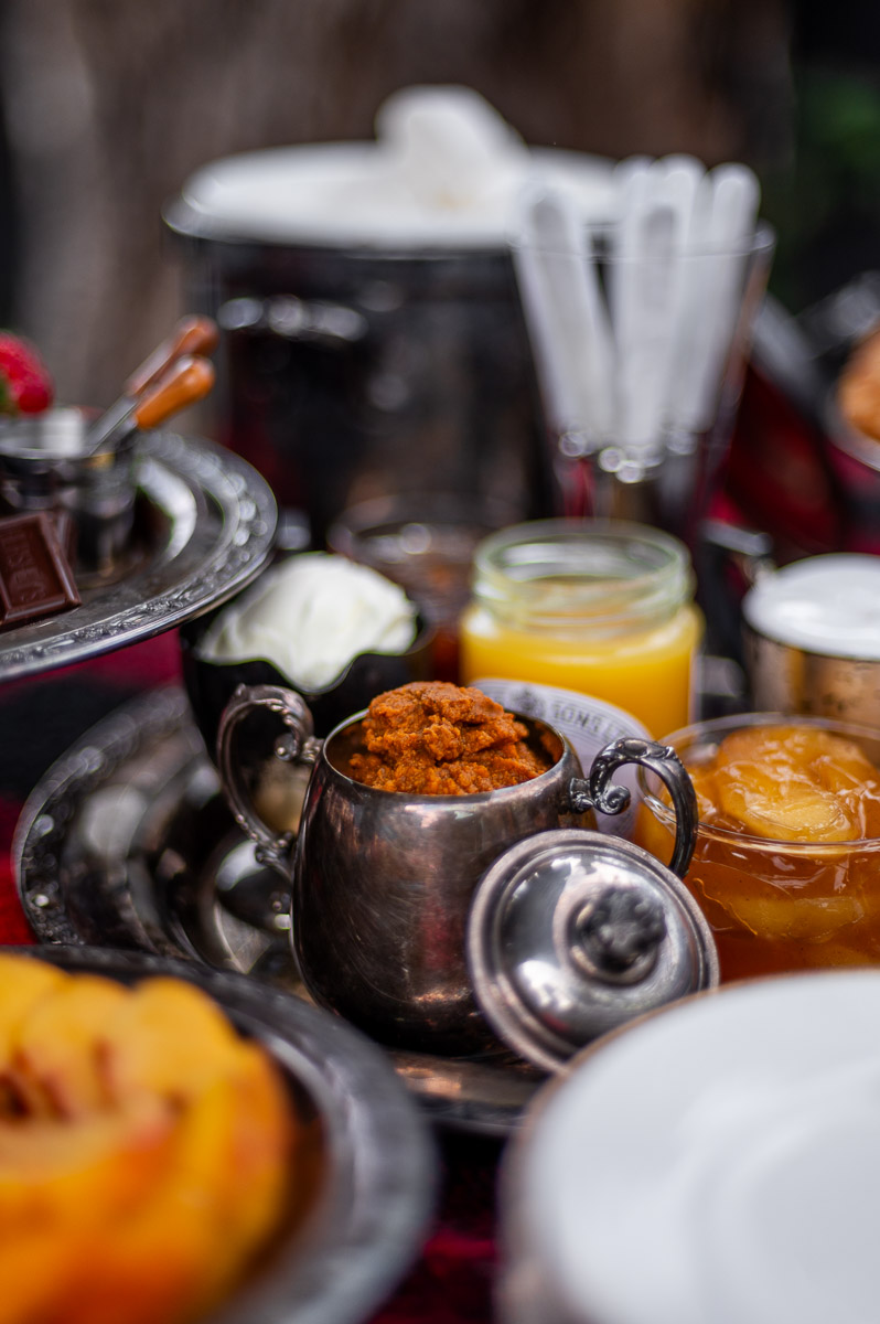 Fig jam, lemon curd, pumpkin spread, mascarpone, apple pie filling and marshmallow fluff in silver serving dishes – creative s’mores grazing table ideas.