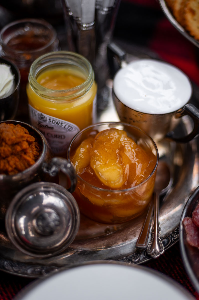 Fig jam, lemon curd, pumpkin spread, and apple pie filling in silver serving dishes – creative s’mores grazing table ideas.