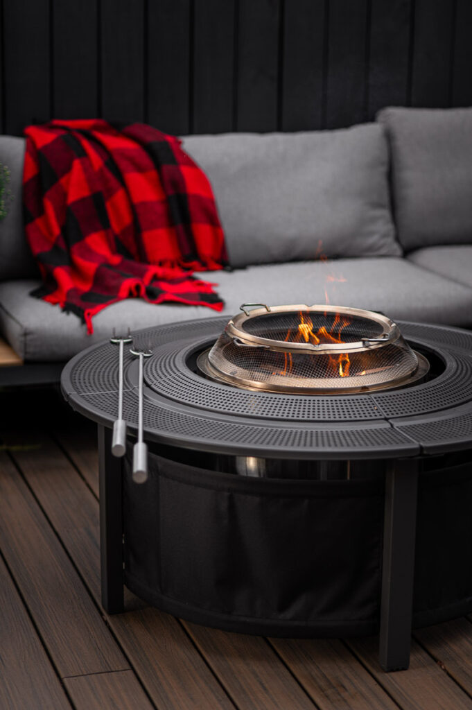 Smokeless fire pit on deck surrounded by cozy outdoor seating at a bonfire party