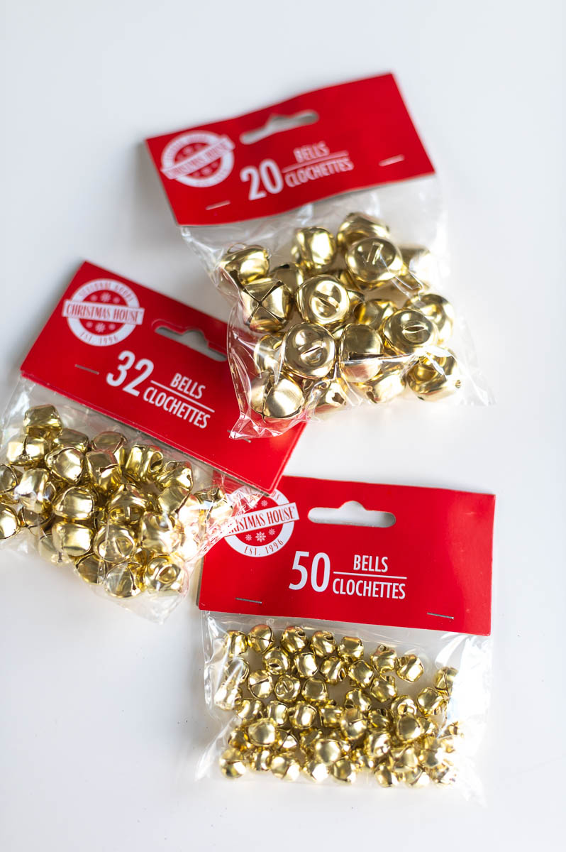 Dollar Tree supplies for DIY jingle bell garland dollar tree christmas craft including three sizes of gold bells