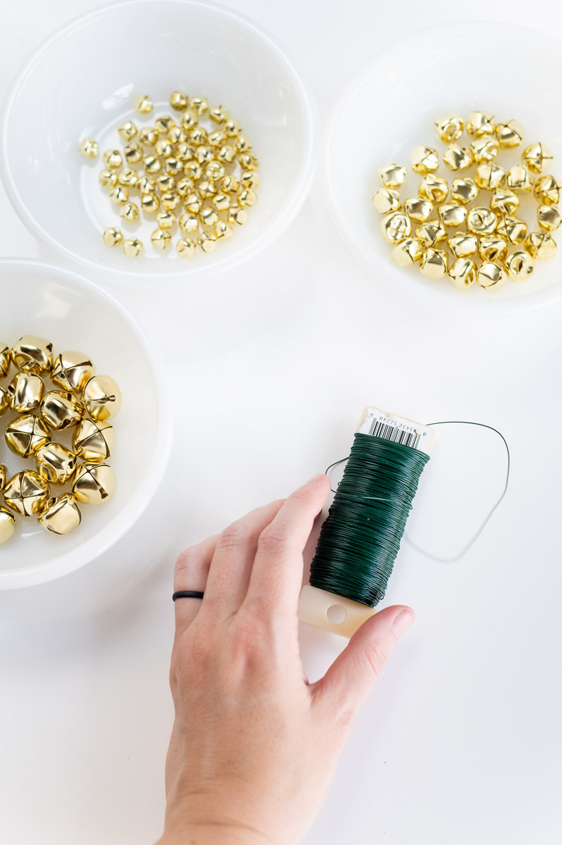 Dollar Tree supplies for DIY jingle bell garland dollar tree christmas craft including gold bells and floral wire