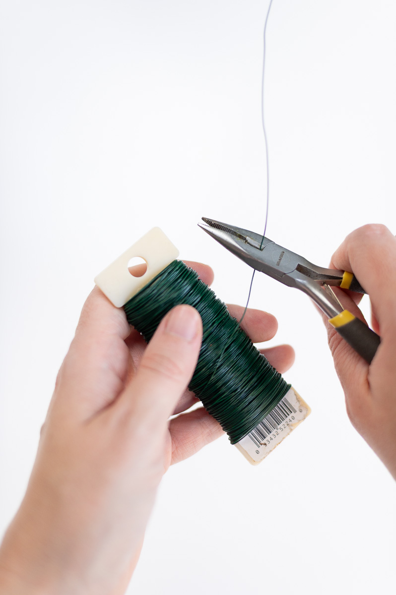 How to prepare floral wire for making DIY Christmas garland with jingle bells