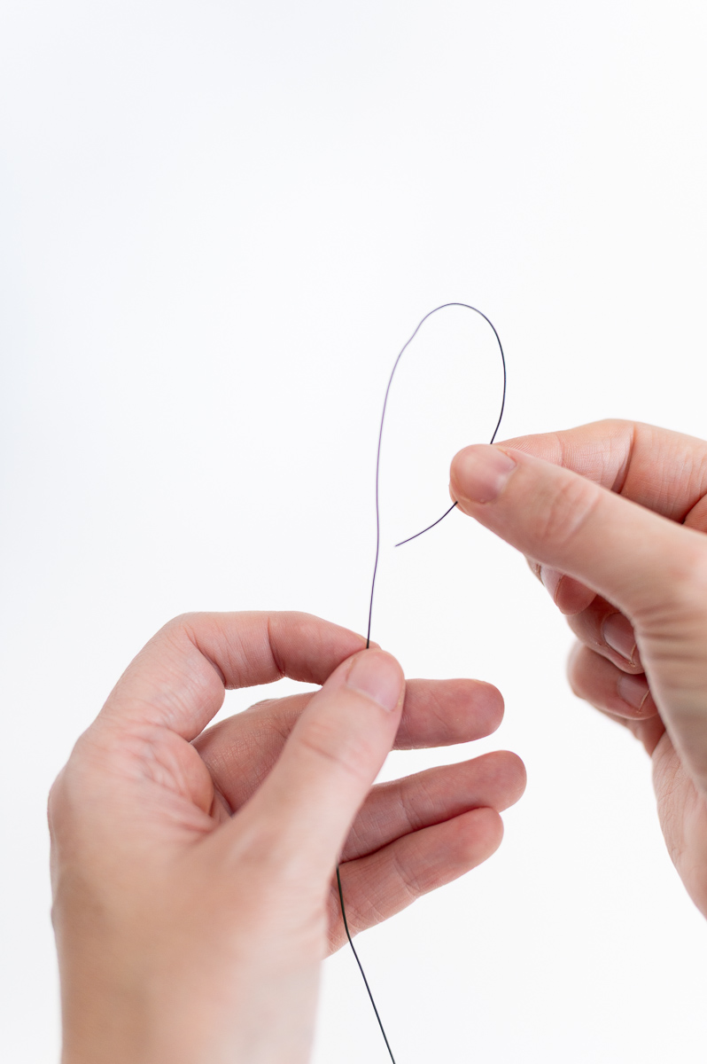 How to prepare floral wire for making DIY Christmas garland with jingle bells