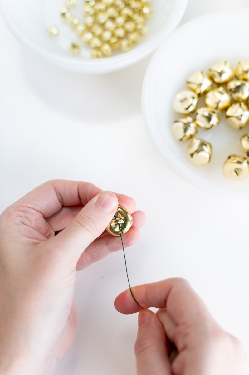 Step by step tutorial showing how to make an elegant christmas garland with gold jingle bells