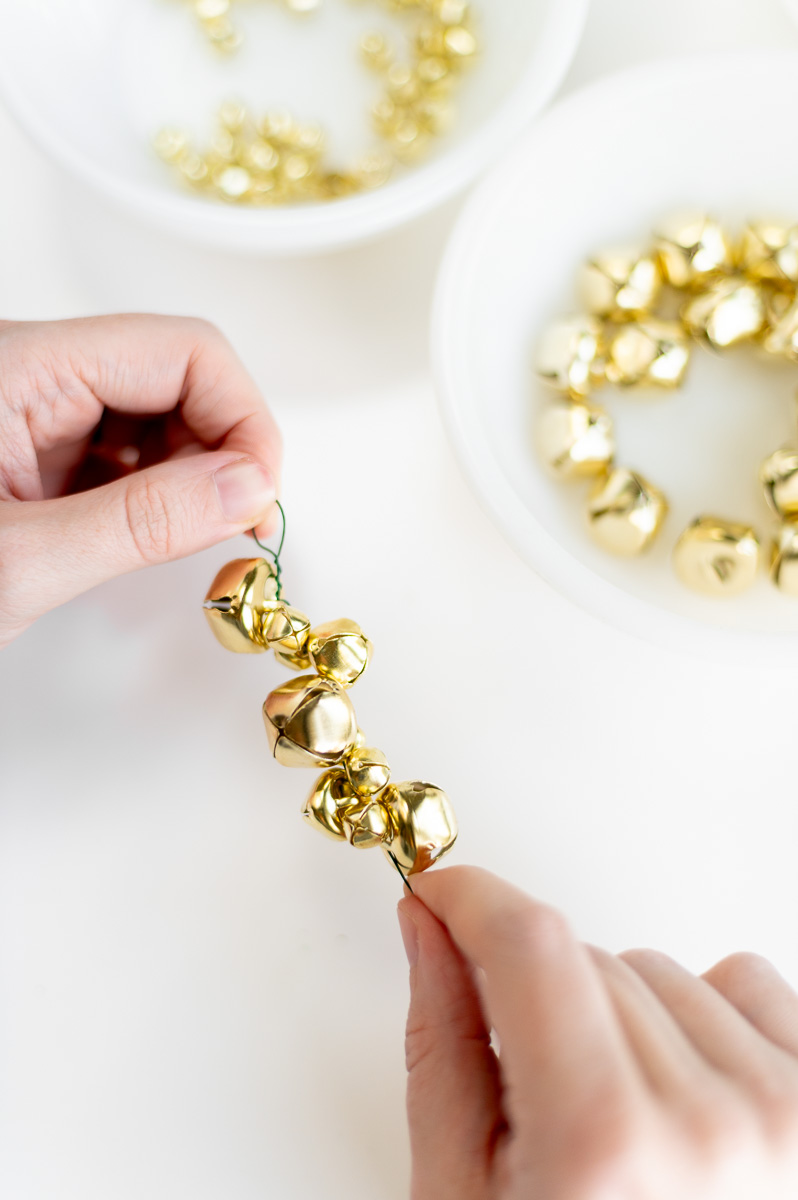 DIY holiday garland tutorial using gold jingle bells for traditional Christmas decor
