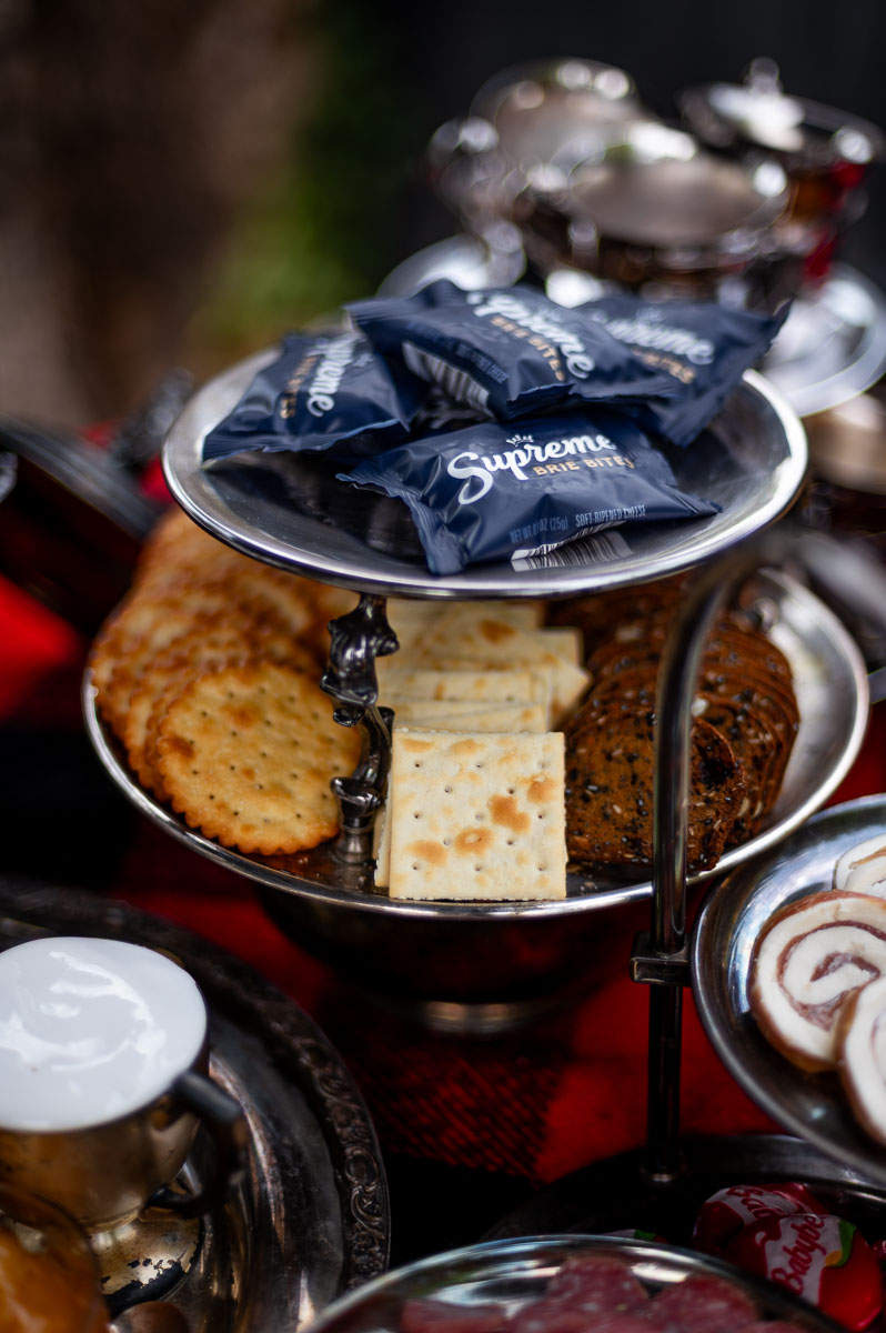 Savory s’mores charcuterie with cheeses, meats, and crackers – unexpected grazing board ideas for bonfire party.