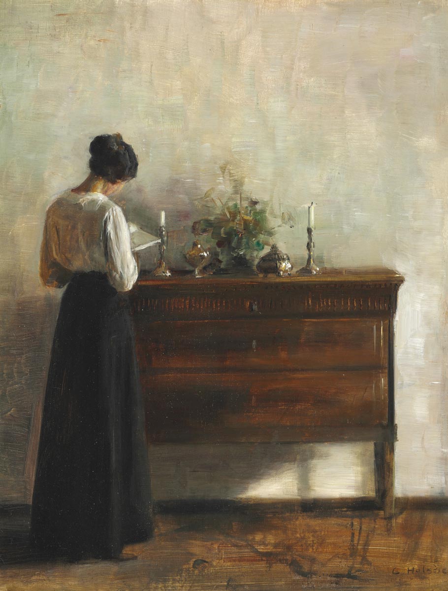 free vintage portrait painting by Carl-Holsoe entitled “Interior with the artists wife standing-at a chest of drawers reading”