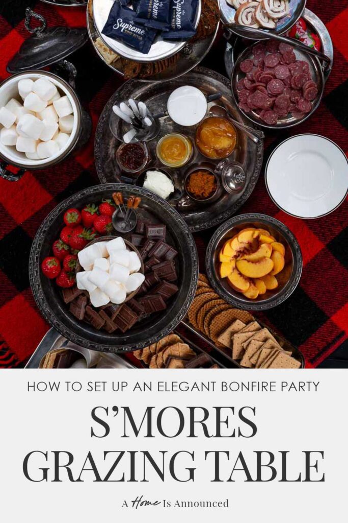 Overhead shot of elegant s’mores charcuterie board on plaid blanket – vintage style grazing table with marshmallows, fruit, cookies, and chocolate.
