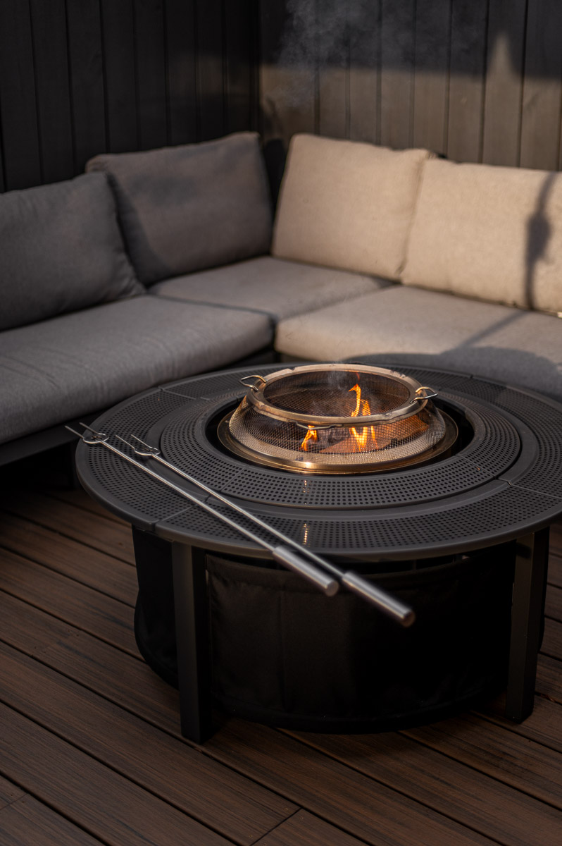 Deck-safe Solo Stove Bonfire setup with spark shield, surround, and roasting sticks for kid safe marshmallow roasting