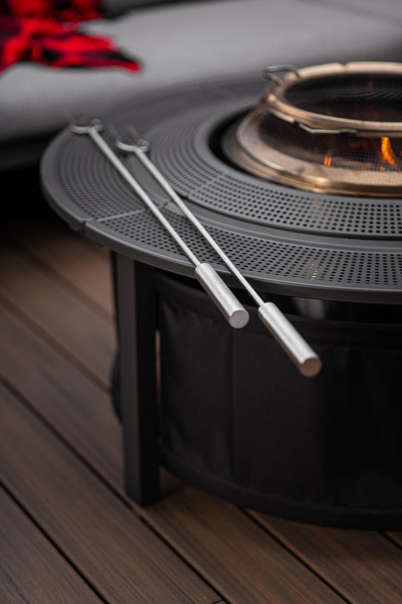Family-ready Solo Stove deck setup with spark guard, surround, and roasting sticks for s’mores