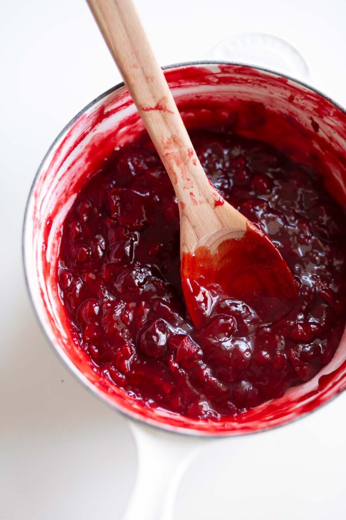 upgraded canned cherry pie filling rests on a table to cool in preparation for making semi homemade cherry hand pies