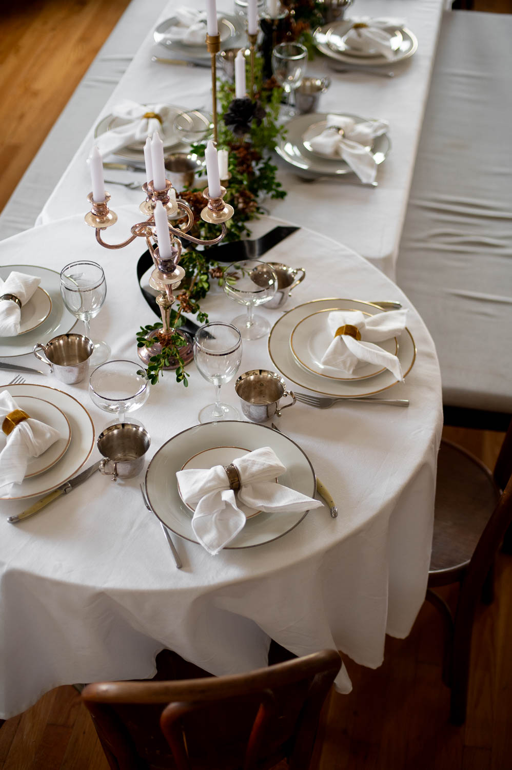 a long table is set for a friendsgiving supper club monthly dinner party with friends