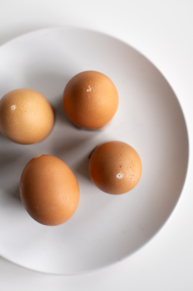 Four blown brown eggs before vinegar lightening for Easter dye