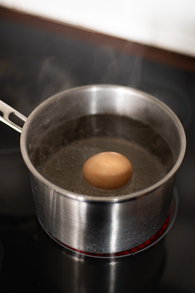 Using heat and vinegar to lighten a brown egg before dyeing it pastel colors for Easter
