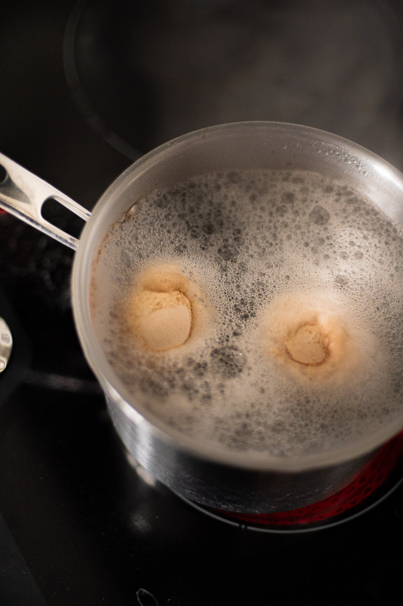 Brown eggs in boiling vinegar and water to speed up lightening process
