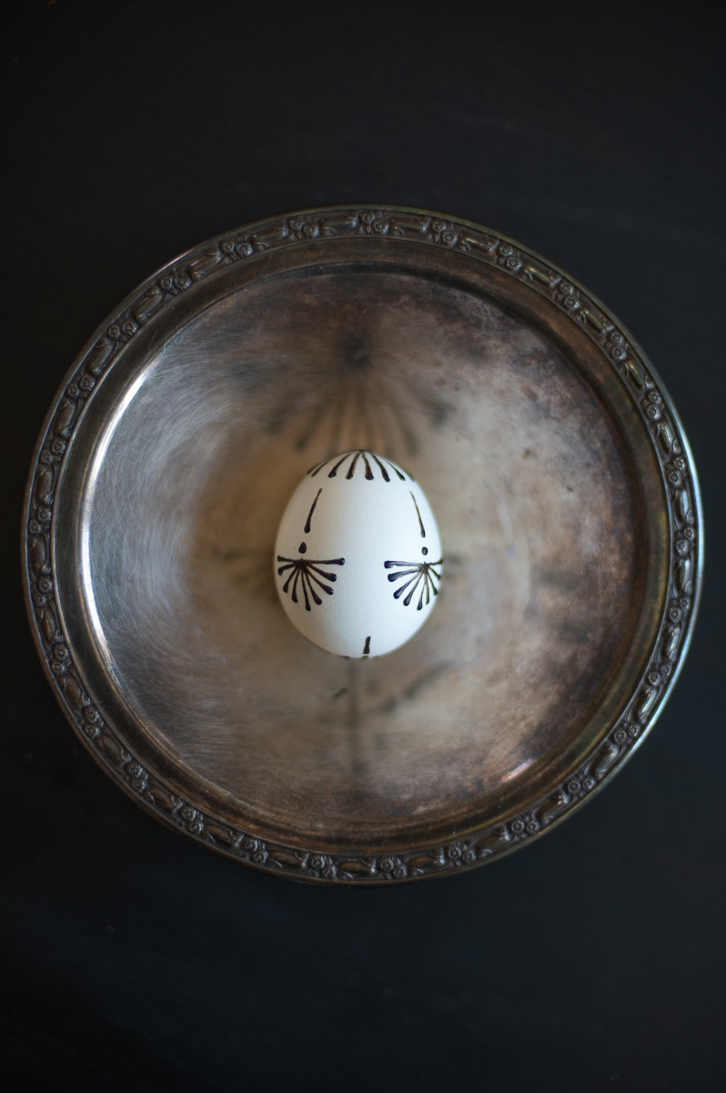 an example of a simple elegant egg decorating design made by drawing with hot crayon wax on Easter eggs