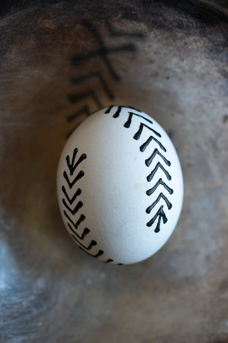 a close-up showing an easy design you can make using traditional pin-drop wax-pull wax methods to decorate Easter eggs with wax.