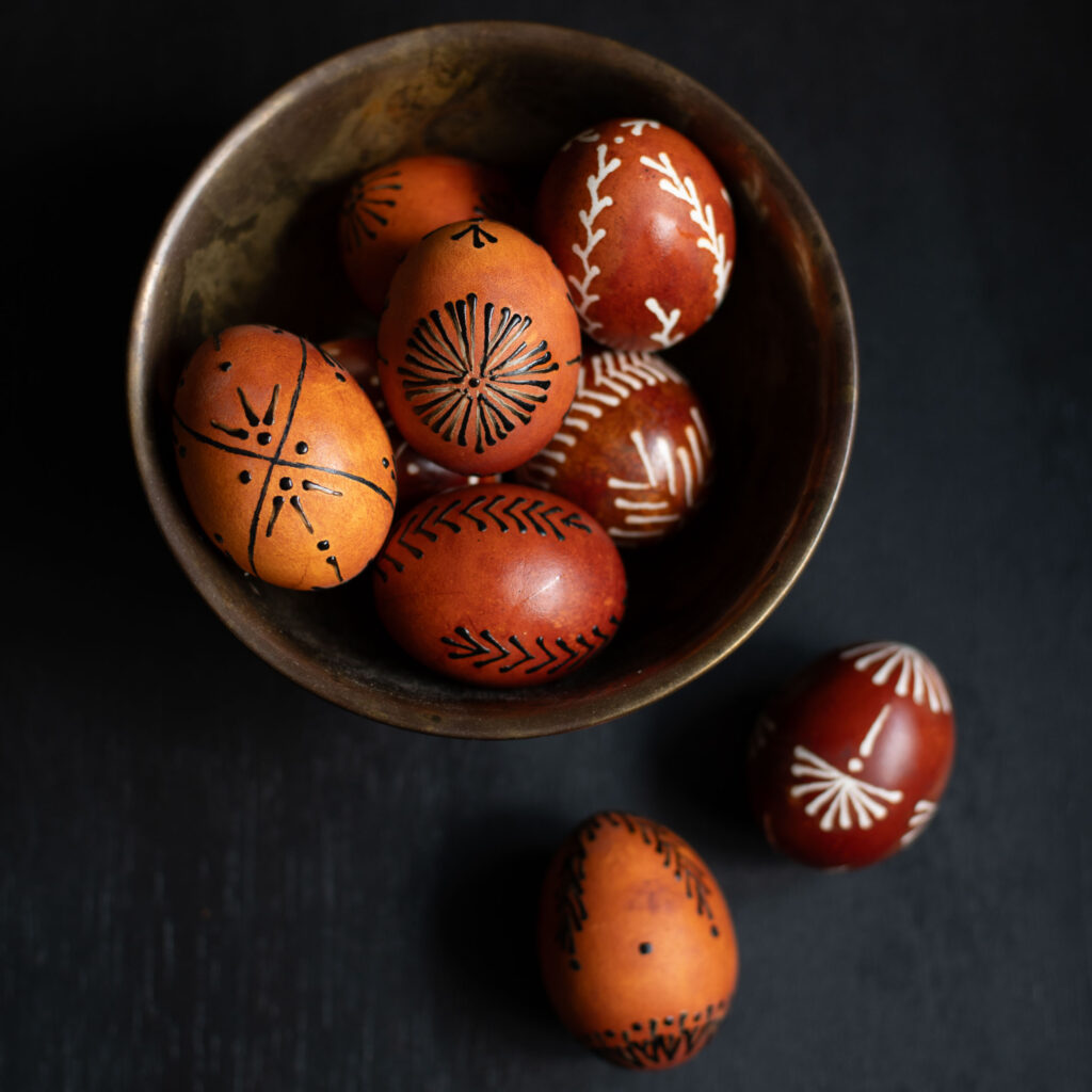 A collection of wax resist easter eggs made with traditional drop-pull wax techniques the pin-drag egg method and crayon wax.